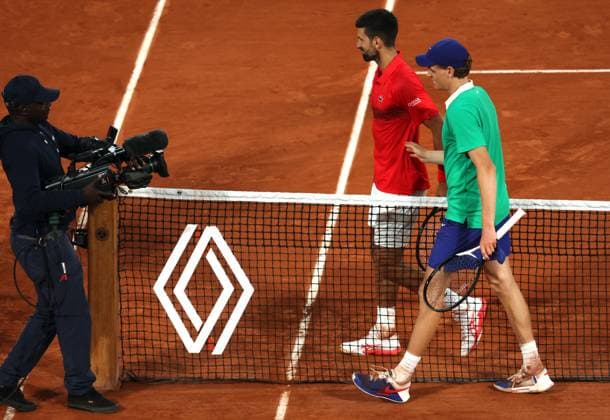 Top-seeded Jannik Sinner of Italy and Serb Novak Djokovic walk to salute the referee at the end of their semi-final match at the French Tennis Open in Roland Garros in Paris, France, on Friday, June 6, 2025. Sinner won 6-4, 7-5, 7-6 and advanced to the final.  PAR20250607221 MAYAxVIDON-WHITE