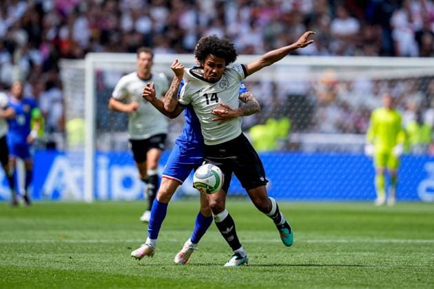 Karim Adeyemi, Lucas Digne battle for the ball, UEFA Nations League 2025 Third Place Match, Germany and France, Stuttgart Arena, June 8, 2025, Stuttgart, Germany.