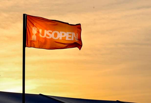 A flag waves at the 125th U.S. Open Golf Championship at Oakmont Country Club in Oakmont, Pennsylvania as the sun sets on Wednesday, June 11, 2025. The tournament will take place from June 12 to June 15, 2025.  PIT2025061211226 ARCHIExCARPENTER