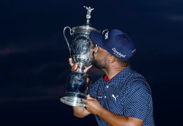 J.J. Spaun kisses the trophy after winning the 125th U.S. Open Golf Championship at Oakmont Country Club in Oakmont, Pennsylvania on Sunday, June 15, 2025. Spaun won with a 64-foot birdie putt on the 18th hole and finished at even par for the tournament.  PIT20250615708 JOHNxANGELILLO