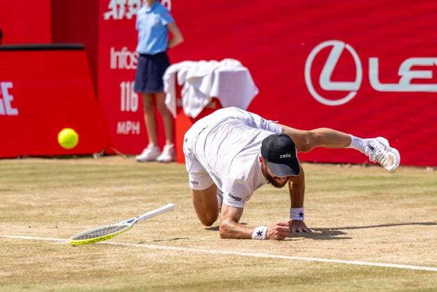 Tennis - 2025 ATP, Tennis Herren Men™s HSBC Championships - Quarter-final - Jacob Fearnley (GBR) vs Corentin Moutet (FRA) - The Queen™s Club - Thursday 19th June 2025 Corentin Moutet (FRA) takes a tumble on the grass as he slips trying to make the return Colorsport Daniel Bearham  csp_ten_quM_db_19062025_