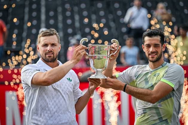 22nd June 2025; HSBC Championships, Queens Club, West Kensington, London, England: HSBC Mens Championships Queens Club, Day 7; Julian Cash (GBR) celebrates winning the mens doubles final match with partner Lloyd Glasspool (GBR) against Nikola Mektic (CRO) and Michael Venus (NZL) as they hold the trophy  ActionPlus12804558 GodfreyxPitt