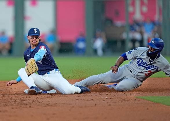 June 27, 2025: Kansas City Royals shortstop Bobby Witt Jr. (7) tries to field a throw on a stolen base by Los Angeles Dodgers outfielder Teoscar HernoÂ¡ndez (37) at Kauffman Stadium Kansas City, Missouri. CSM. Kansas City United States - ZUMAc04_ 20250627_zma_c04_030 Copyright: xJonxRobichaudx