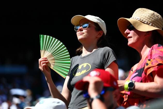A spectator tries to keep cool during Jacob Fearnley v Joao Fonseca Wimbledon Tennis Championships, Day 1, The All England Lawn Tennis and Croquet Club, London, UK - 30 Jun 2025London The All England Lawn Tennis and United Kingdom  Copyright: xJamesxMarsh Shutterstockx 15378842di