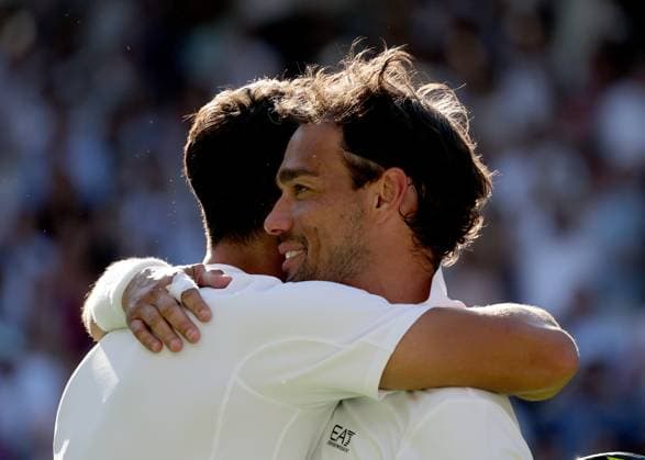 30th June 2025; All England Lawn Tennis and Croquet Club, London, England; Wimbledon Tennis Tournament, Day 1; Carlos Alcaraz (ESP) congratulated by Fabio Fognini (ITA) after defeating the Italian by three sets to two to reach the 2nd round  ActionPlus12807292 JohnxPatrickxFletcher