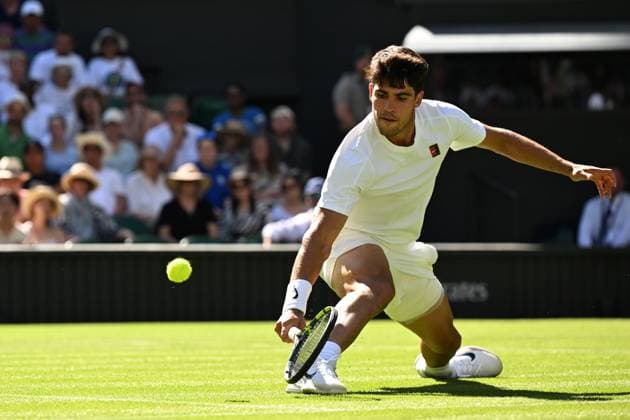 (250701) -- LONDON, July 1, 2025 -- Carlos Alcaraz hits a return during the men s singles first round match between Carlos Alcaraz of Spain and Fabio Fognini of Italy at Wimbledon Tennis Championship in London, Britain, June 30, 2025. ) ) (SP)BRITAIN-LONDON-TENNIS-WIMBLEDON-MEN S SINGLES ZhaoxDingzhe 
