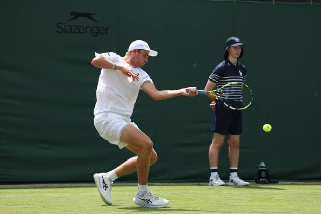 1st July 2025; All England Lawn Tennis and Croquet Club, London, England; Wimbledon Tennis Tournament, Day 2; Johannus Monday (GBR) with a forehand shot to Tommy Paul (USA)  ActionPlus12807385 JohnxPatrickxFletcher