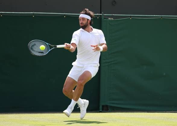 1st July 2025; All England Lawn Tennis and Croquet Club, London, England; Wimbledon Tennis Tournament, Day 2; Nikoloz Basilashvili (GRO) with a forehand shot to Lorenzo Musetti (ITA)  ActionPlus12807394 JohnxPatrickxFletcher