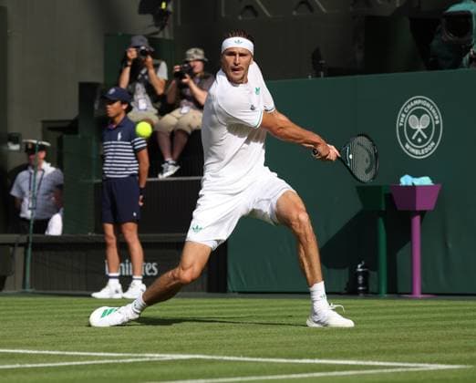 German Alexander Zverev plays a backhand in his match against France s Arthur Rinderknech on day two of the 2025 Wimbledon Championships in London on Tuesday, July 01, 2025.  LON2025070148 HUGOxPHILPOTT