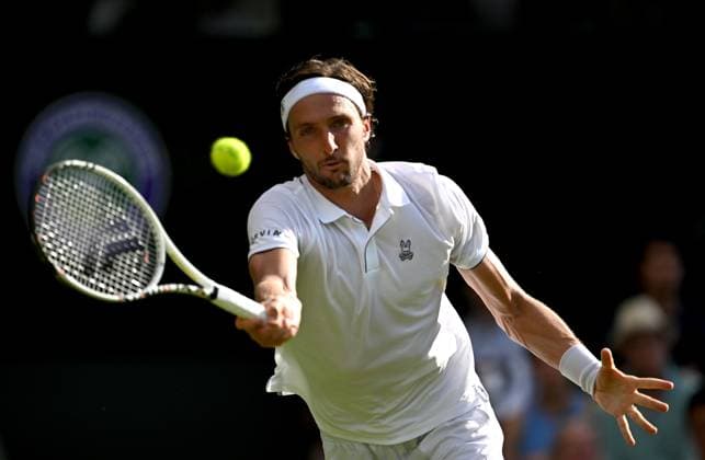 (250702) -- LONDON, July 2, 2025 -- Arthur Rinderknech hits a return during the men s singles first round match between Alexander Zverev of Germany and Arthur Rinderknech of France at the Wimbledon Tennis Championships in London, Britain, July 1, 2025. ) (SP)BRITAIN-LONDON-TENNIS-WIMBLEDON-MEN S SINGLES LixYing 