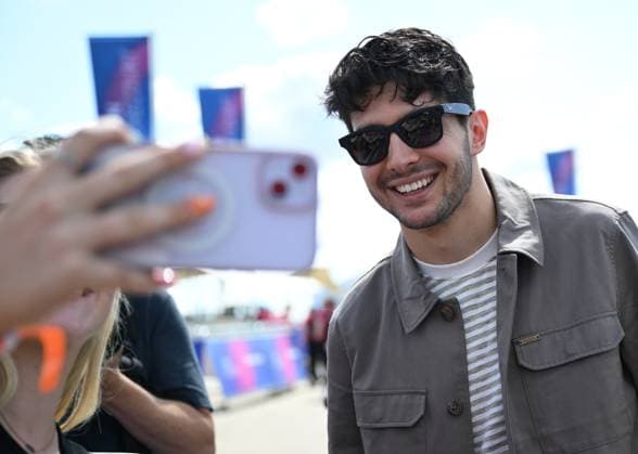 3rd July 2025; Silverstone Circuit, Northamptonshire, England; Formula 1 2025 Qatar Airways British F1 Grand Prix; Arrivals and Inspection Day; Esteban Ocon of Haas poses for photos with fans on arrival at Silverstone  ActionPlus12808246 SimonxWest