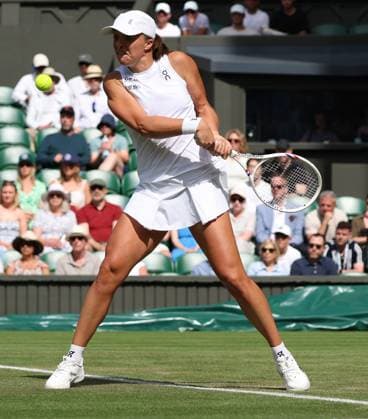 Poland s Iga Swiatek plays a backhand in her second round match against American Caty Mcnally on day four of the 2025 Wimbledon Championships in London on Thursday, June 03, 2025.  LON2025070330 HUGOxPHILPOTT