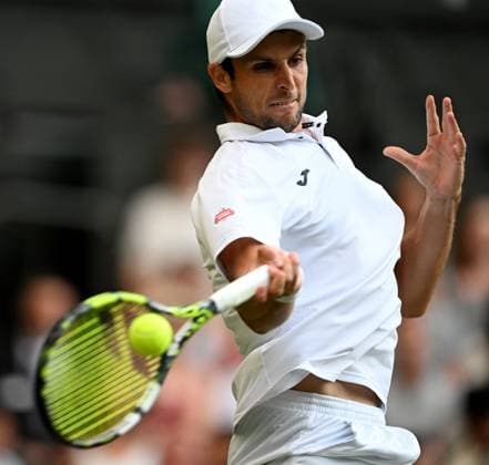 (250704) -- LONDON, July 4, 2025 -- Aleksandar Vukic hits a return during the men s singles second round match between Jannik Sinner of Italy and Aleksandar Vukic of Australia at the Wimbledon Tennis Championships in London, Britain, July 3, 2025. ) (SP)BRITAIN-LONDON-TENNIS-WIMBLEDON-MEN S SINGLES LixYing 