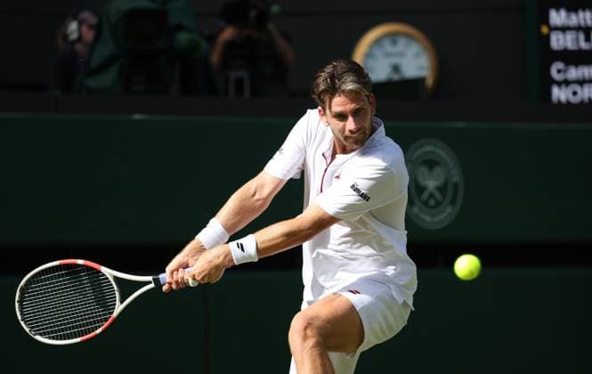 Great Britain s Cameron Norrie plays a backhand in his third round match against Italian Mattia Bellucci on day five of the 2025 Wimbledon Championships in London on Friday, July 04, 2025.  LON2025070468 HUGOxPHILPOTT