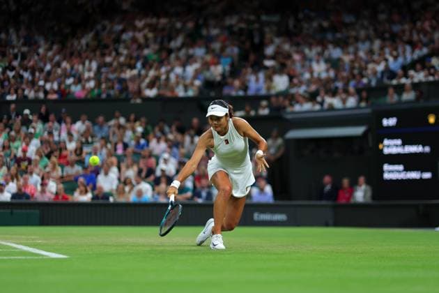 4th July 2025; All England Lawn Tennis and Croquet Club, London, England; Wimbledon Tennis Tournament, Day 5; Emma Raducanu (GBR) with a backhand shot to Aryna Sabalenka (BLR)  ActionPlus12809195 JohnxPatrickxFletcher