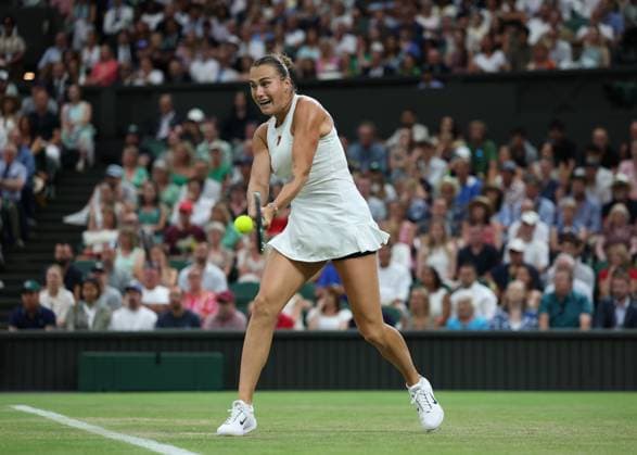 4th July 2025; All England Lawn Tennis and Croquet Club, London, England; Wimbledon Tennis Tournament, Day 5; Aryna Sabalenka (BLR) with a backhand shot to Emma Raducanu (GBR)  ActionPlus12809207 JohnxPatrickxFletcher