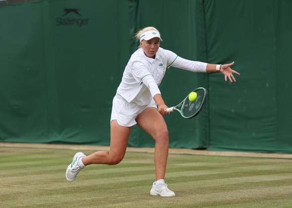 5th July 2025; All England Lawn Tennis and Croquet Club, London, England; Wimbledon Tennis Tournament, Day 6; Clara Tauson (DEN) with a backhand shot to Elena Rybakina (KAZ)  ActionPlus12809301 JohnxPatrickxFletcher