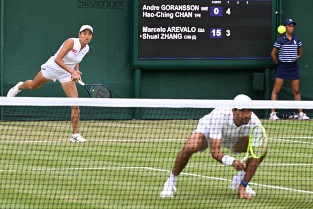 (250705) -- LONDON, July 5, 2025 -- Zhang Shuai (L) Marcelo Arevalo compete during the mixed doubles first round match between Zhang Shuai of China Marcelo Arevalo of El Salvador and Chan Hao-Ching of Chinese Taipei Andre Goransson of Sweden at the Wimbledon Tennis Championships in London, Britain, July 5, 2025. ) (SP)BRITAIN-LONDON-TENNIS-WIMBLEDON-MIXED DOUBLES ZhaoxDingzhe 