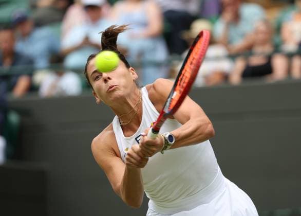 USA s Emma Navarro plays a backhand in her third round match against Czech Barbora Krejcikova on day six of the 2025 Wimbledon Championships in London on Saturday, July 05, 2025.  LON2025070539 HUGOxPHILPOTT