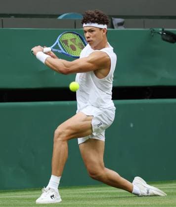 USA s Ben Shelton plays a backhand in his third round match against Hungary s Marton Fucsovics on day six of the 2025 Wimbledon Championships in London on Saturday, July 05, 2025.  LON2025070593 HUGOxPHILPOTT