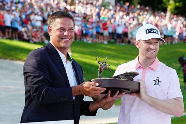 SILVIS, IL - JULY 06: PGA, Golf Herren golfer Brian Campbell is presented the trophy after winning in a playoff on the 18th hole during the final round for the John Deere Classic on July 6, 2025, at TPC Deere Run in Silvis, Illinois. (Photo by Brian Spurlock Icon Sportswire) GOLF: JUL 06 PGA John Deere Classic EDITORIAL USE ONLY Icon250706106