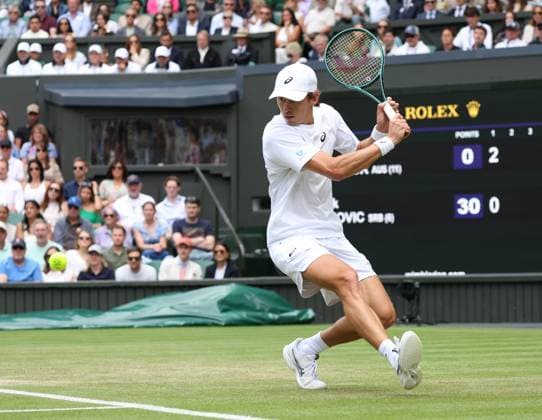 Australia s Alex De Minaur plays a backhand in his fourth round match against Serbian Novak Djokovic on day eight of the 2025 Wimbledon Championships in London on Monday, July 07, 2025.  LON2025070720a HUGOxPHILPOTT
