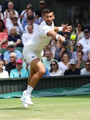 Serbian Novak Djokovic plays a backhand in his fourth round match against Australia s Alex De Minaur on day eight of the 2025 Wimbledon Championships in London on Monday, July 07, 2025.  LON2025070724 HUGOxPHILPOTT