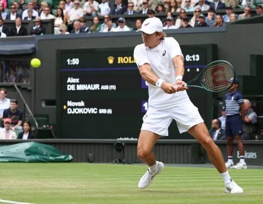 Australia s Alex De Minaur plays a backhand in his fourth round match against Serbian Novak Djokovic on day eight of the 2025 Wimbledon Championships in London on Monday, July 07, 2025.  LON2025070727 HUGOxPHILPOTT