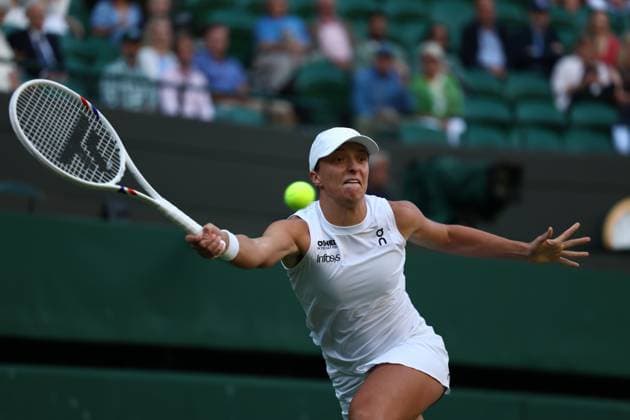 7th July 2025; All England Lawn Tennis and Croquet Club, London, England; Wimbledon Tennis Tournament, Day 8; Iga Swiatek (POL) with a forehand shot to Clara Tauson (DEN)  ActionPlus12811315 JohnxPatrickxFletcher