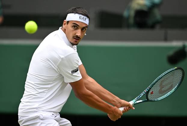 (250708) -- LONDON, July 8, 2025 -- Lorenzo Sonego hits a return during the men s singles round of 16 match between Ben Shelton of the United States and Lorenzo Sonego of Italy at the Wimbledon Tennis Championships in London, Britain, July 7, 2025 ) (SP)BRITAIN-LONDON-TENNIS-WIMBLEDON-MEN S SINGLES ZhaoxDingzhe 