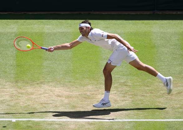 8th July 2025; All England Lawn Tennis and Croquet Club, London, England; Wimbledon Tennis Tournament, Day 9; Taylor Fritz (USA) with a forehand shot to Karen Khachanov (RUS) mens singles quarter-final match  ActionPlus12811388 JohnxPatrickxFletcher