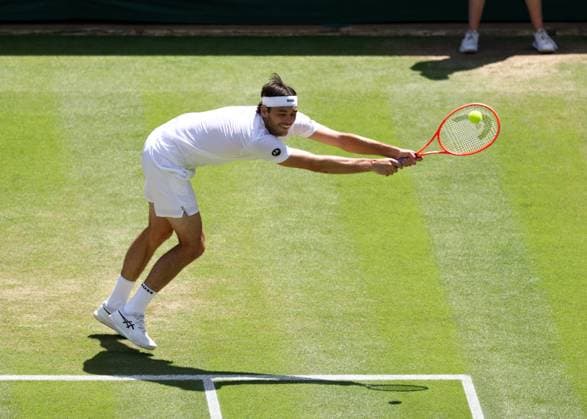 8th July 2025; All England Lawn Tennis and Croquet Club, London, England; Wimbledon Tennis Tournament, Day 9; Taylor Fritz (USA) with a backhand shot to Karen Khachanov (RUS)  ActionPlus12811389 JohnxPatrickxFletcher
