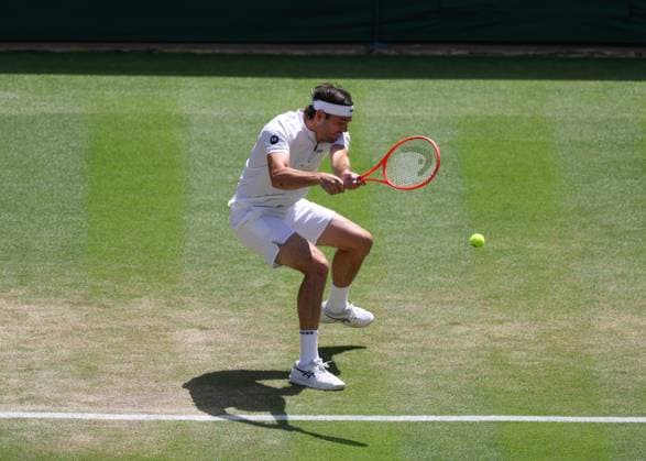 8th July 2025; All England Lawn Tennis and Croquet Club, London, England; Wimbledon Tennis Tournament, Day 9; Taylor Fritz (USA) with a backhand shot to Karen Khachanov (RUS), mens singles quarter-final match  ActionPlus12811395 JohnxPatrickxFletcher