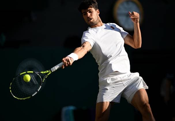 (250709) -- LONDON, July 9, 2025 -- Carlos Alcaraz hits a return during the men s singles quarterfinal match between Carlos Alcaraz of Spain and Cameron Norrie of Britain at the Wimbledon Tennis Championships in London, Britain, July 8, 2025. ) (SP)BRITAIN-LONDON-TENNIS-WIMBLEDON-MEN S SINGLES LixYing 