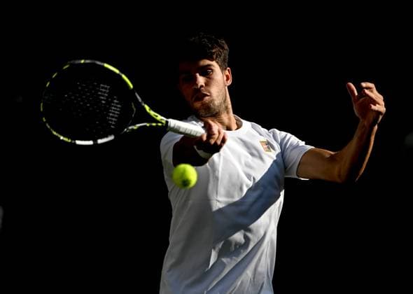 (250709) -- LONDON, July 9, 2025 -- Carlos Alcaraz hits a return during the men s singles quarterfinal match between Carlos Alcaraz of Spain and Cameron Norrie of Britain at the Wimbledon Tennis Championships in London, Britain, July 8, 2025. ) (SP)BRITAIN-LONDON-TENNIS-WIMBLEDON-MEN S SINGLES LixYing 