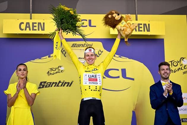 Slovenian Tadej Pogacar of UAE Team Emirates celebrates on the podium in the yellow jersey of leader in the overall ranking after stage five of the 2025 Tour de France cycling, a 33km time trial in Caen, France on Wednesday 09 July 2025. The 112th edition of the Tour de France starts on Saturday 5 July in Lille, France, and will finish in Paris, France on the 27th of July. JASPERxJACOBS  x128773547x