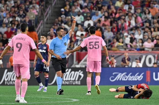 July 9, 2025; Foxborough, Massachusetts, USA; Referee Fotis Bazakos gives Inter Miami midfielder Federico Redondo (55) a yellow card warning for contact against New England Revolution midfielder Carles Gil (10) during the second half at Gillette Stadium. CSM Foxborough USA - ZUMAc04_ 20250709_zma_c04_098 Copyright: xEricxCanhax