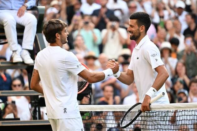 (250710) -- LONDON, July 10, 2025 -- Novak Djokovic (R) shakes hands with Flavio Cobolli after the men s singles quarterfinal match between Novak Djokovic of Serbia and Flavio Cobolli of Italy at the Wimbledon Tennis Championships in London, Britain, July 9, 2025. ) (SP)BRITAIN-LONDON-TENNIS-WIMBLEDON-MEN S SINGLES ZhaoxDingzhe 