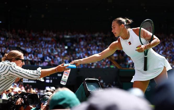 Aryna Sabalenka hands a bottle of water and an icepack to someone in the crowd after a medical emergency Wimbledon Tennis Championships, Day 11, The All England Lawn Tennis and Croquet Club, London, UK - 10 Jul 2025London The All England Lawn Tennis and United Kingdom  Copyright: xJamesxMarsh Shutterstockx 15390590x