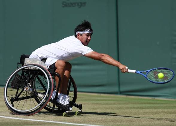 9th July 2025; All England Lawn Tennis and Croquet Club, London, England; Wimbledon Tennis Tournament, Day 10; Zhenxu Ji (CHN) with a backhand shot to Alfie Hewett (GBR) in their mens wheelchair singles quarter-final  ActionPlus12811994 JohnxPatrickxFletcher