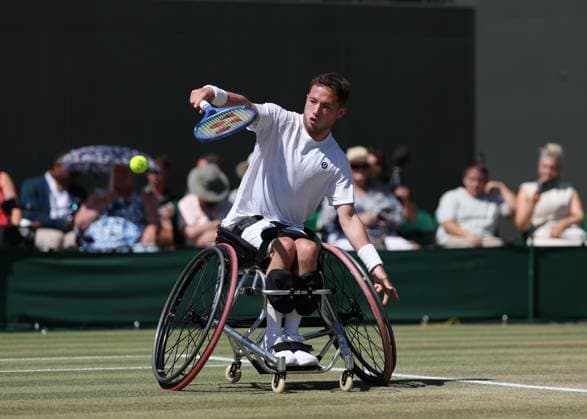 9th July 2025; All England Lawn Tennis and Croquet Club, London, England; Wimbledon Tennis Tournament, Day 10; Alfie Hewett (GBR) with a backhand shot to Zhenxu Ji (CHN) in their mens wheelchair singles quarter-final  ActionPlus12811996 JohnxPatrickxFletcher