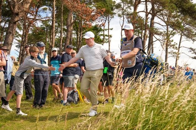 Robert MacIntyre (SCO) high fives a young fan as he walks towards the 18th fairway with his caddie Mike Burrows Genesis Scottish Open, Day 1, Golf, Renaissance Club, North Berwick, Scotland, UK - 10 Jul 2025North Berwick Scotland United Kingdom EDITORIAL USE ONLY No use with unauthorised audio, video, data, fixture lists, club league logos or live services. Online in-match use limited to 120 images, no video emulation. No use in betting, games or single club league player publications. Copyright: xStuartxWallace Shutterstockx 15393027bt