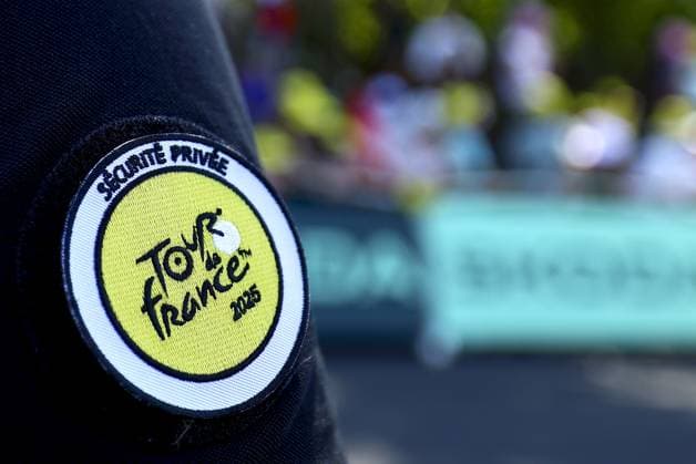 a security guard at stage six of the 2025 Tour de France cycling, from Bayeux to Vire Normandie (201 km), on Thursday 10 July 2025 in France. The 112th edition of the Tour de France starts on Saturday 5 July in Lille, France, and will finish in Paris, France on the 27th of July. DAVIDxPINTENS  x128846213x