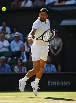(250712) -- LONDON, July 12, 2025 -- Novak Djokovic hits a return during the men s singles semifinal match between Jannik Sinner of Italy and Novak Djokovic of Serbia at the Wimbledon Tennis Championships in London, Britain, July 11, 2025. ) (SP)BRITAIN-LONDON-TENNIS-WIMBLEDON-MEN S SINGLES ZhaoxDingzhe 