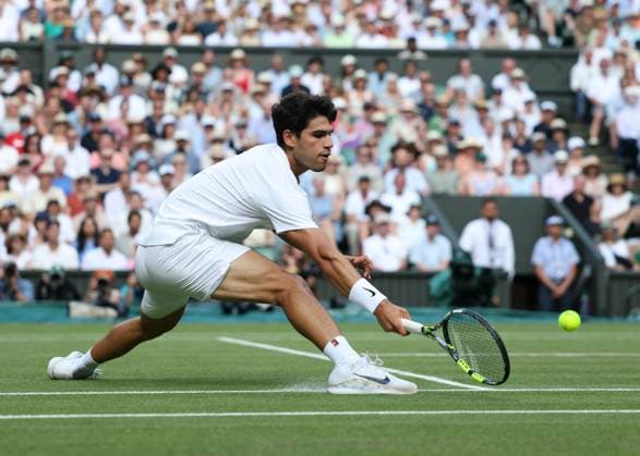13th July 2025; All England Lawn Tennis and Croquet Club, London, England; Wimbledon Tennis Tournament, Day 14; Carlos Alcaraz (ESP) dig deep with a forehand shot to Jannik Sinner (ITA) , mens singles final match  ActionPlus12813409 JohnxPatrickxFletcher