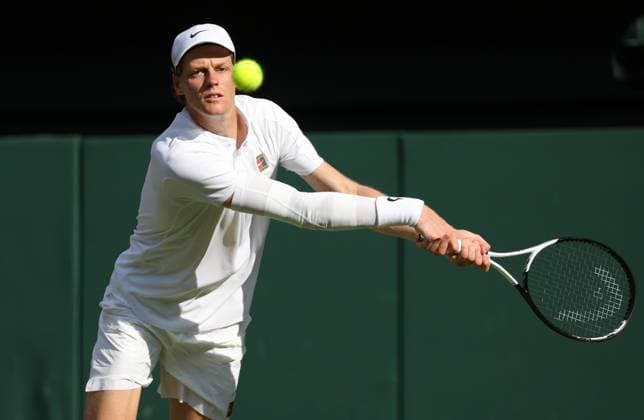 Italian Jannik Sinner plays a backhand during the Wimbledon Men s Singles Final against Spain s Carlos Alcaraz on day fourteen of the 2025 Wimbledon Championships in London on Sunday, July 13, 2025.  LON2025071337 HUGOxPHILPOTT