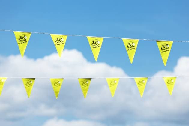 Yellow flags pictured at the start of stage 10 of the 2025 Tour de France cycling, from Ennezat to Le Mont-Dore Puy de Sancy (169 km), on Monday 14 July 2025 in France. The 112th edition of the Tour de France starts on Saturday 5 July in Lille, France, and will finish in Paris, France on the 27th of July. JASPERxJACOBS  x129215500x