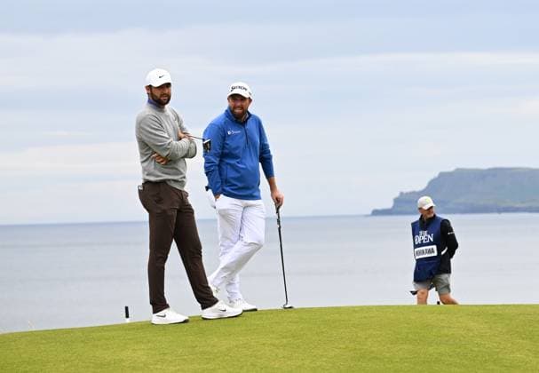 American Scottie Scheffler and Ireland s Shane Lowry chat during the first round at the 153rd Open Championship at Royal Portrush Golf Club in Portrush, Northern Ireland on Thursday, July 17, 2025.  LON2025071703 HUGOxPHILPOTT