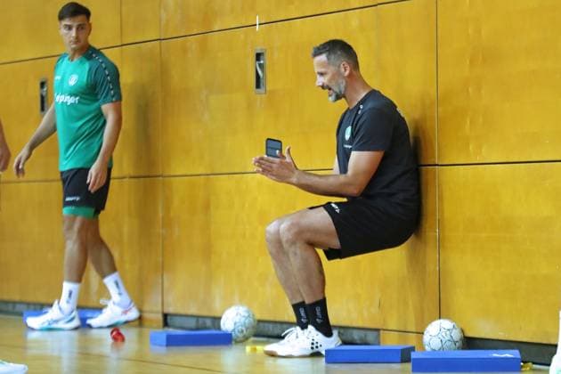 HBL1: Trainingsauftakt des SC DHfK Leipzig, 17.07.25 Athletiktrainer Hagen Pietrek (SC DHfK Leipzig) erklärt die Übung, Wandsitzen. Handball, DAIKIN HBL, Saison 2025 2026, Trainingsauftakt des SC DHfK Leipzig am 17.07.25 in der Quarterback Immobilien Arena Leipzig Kleine Arena. Copyright: xBEAUTIFULxSPORTS JanxKaeferx
