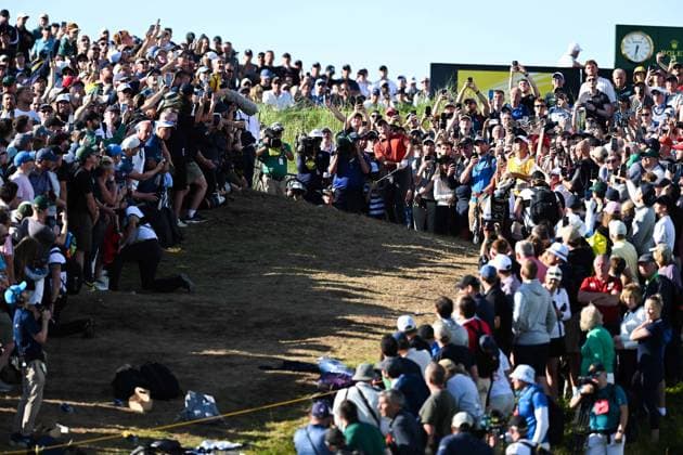 Rory McIlroy plays a shot over massive crowds on the 17th fairway after playing from within the spectator embankment The Open Championship, Day Three, Golf, Royal Portrush Golf Club, Portrush, Northern Ireland, UK - 19 Jul 2025 EDITORIAL USE ONLY No use with unauthorised audio, video, data, fixture lists, club league logos or live services. Online in-match use limited to 120 images, no video emulation. No use in betting, games or single club league player publications.  Copyright: xGreigxCowie Shutterstockx 15403239an